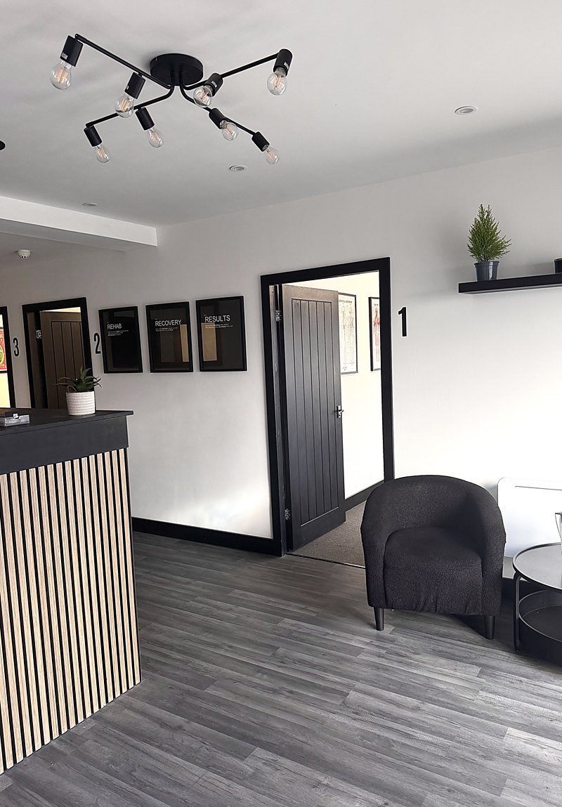 Reception and the numbered treatment rooms at RE:UP Altrincham